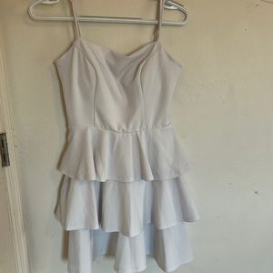 White dress with ruffles in the front.